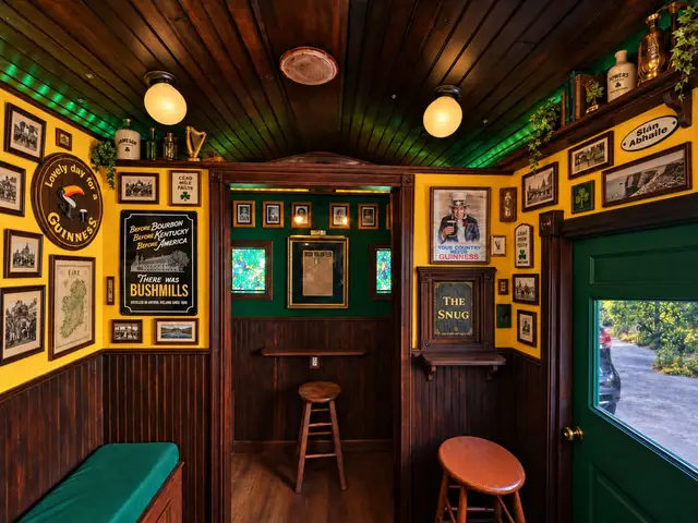 Inside The Síbín — the snug doorway, framed Irish history and a Guinness sign on the yellow walls