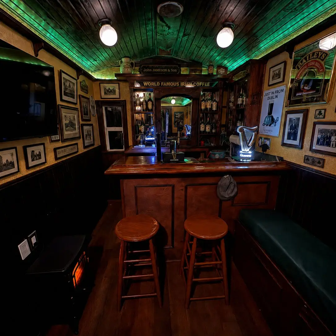 The bar and snug seating inside The Síbín, with Irish prints and a turf stove